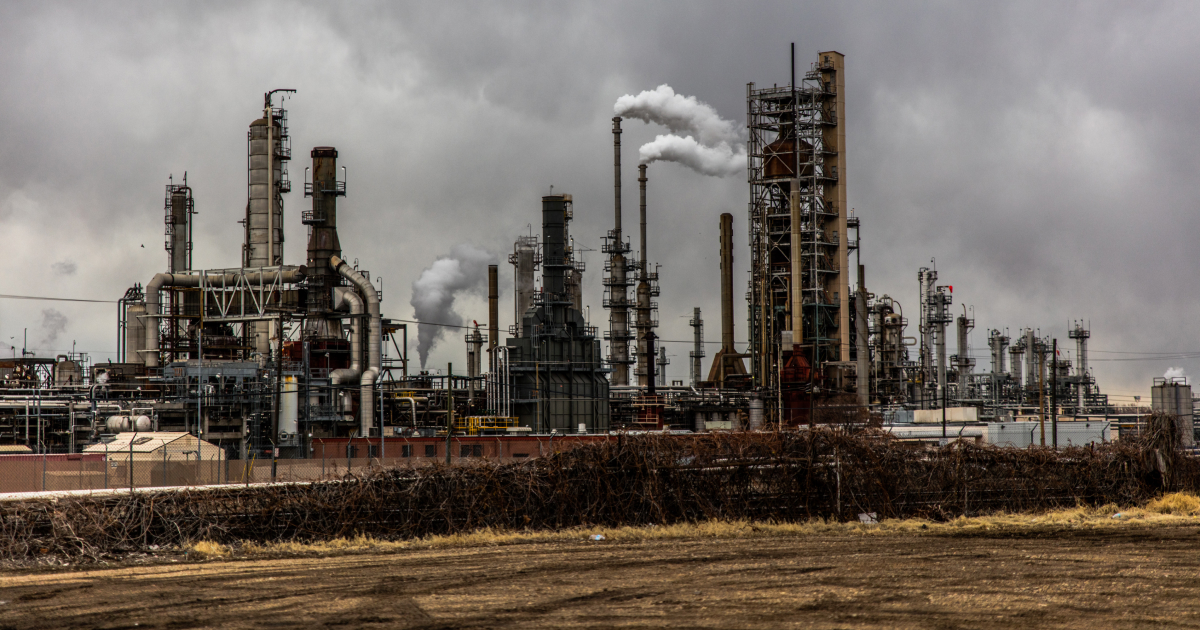 CCS benefits the oil and gas industry. Does it provide returns for communities and investors? (Photo by [Patrik Hendry, Unsplash](https://unsplash.com/photos/factories-with-smoke-under-cloudy-sky-6xeDIZgoPaw))