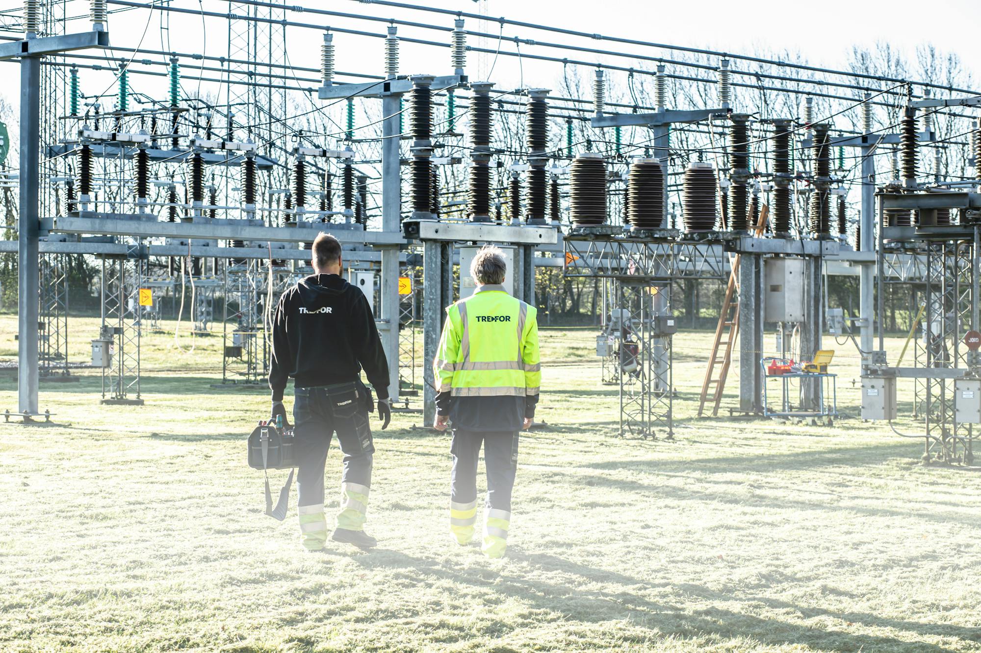 Workers inspecting an electrical substation