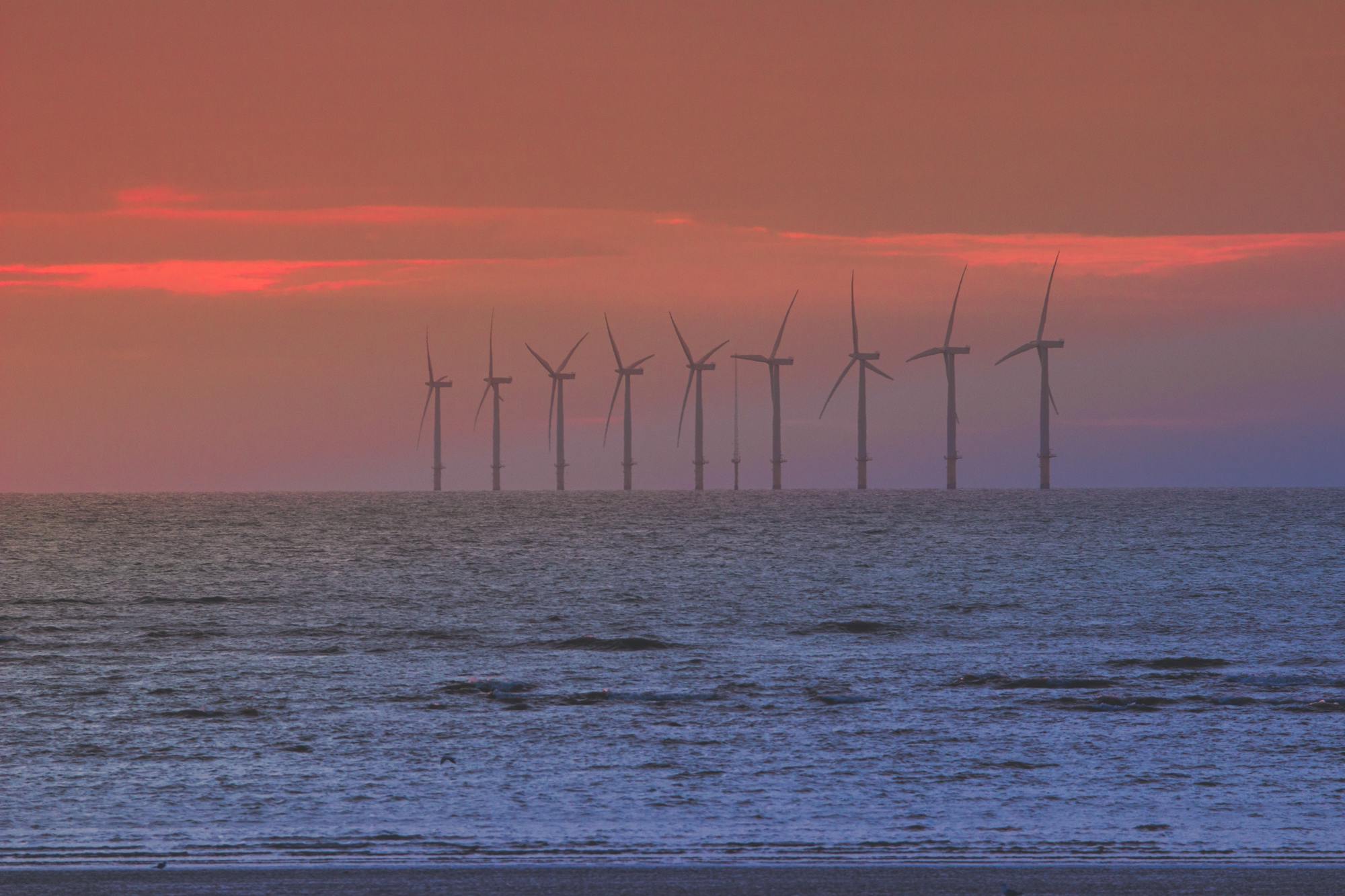 Offshore wind turbines at sunset